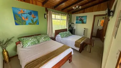 a bedroom with two beds and a window at Brumas de Valverde in Monteverde Costa Rica
