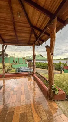 a pavilion with a wooden roof with a tree at Brumas de Valverde in Monteverde Costa Rica