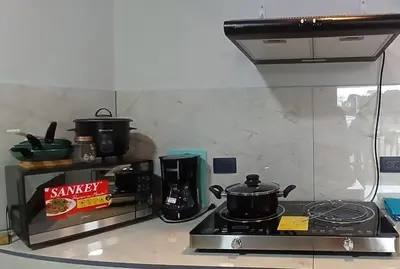 a kitchen with a stove with pots and pans on it at Apartamentos Jireh in Quepos