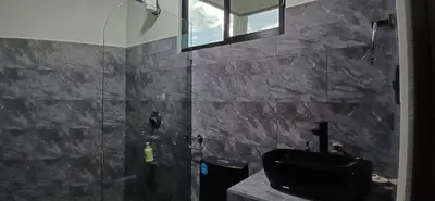 a bathroom with a black sink and a shower at Apartamentos Jireh in Quepos