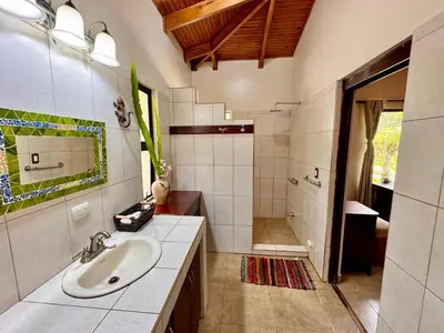 a bathroom with a sink and a shower at Cloud Forest Villas- Eco Lux - All Inclusive