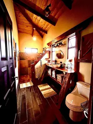 a bathroom with a toilet and a sink at Cloud Forest Villas- Eco Lux - All Inclusive