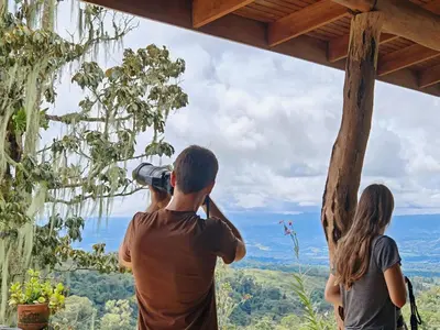 a man taking a picture of a group of people at Cloud Forest Villas- Eco Lux - All Inclusive