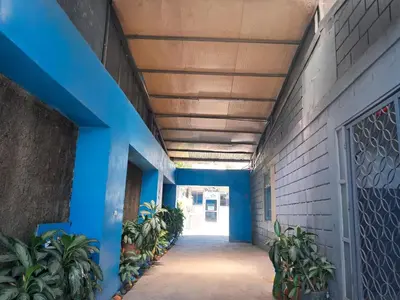 a hallway of a building with blue walls and plants at Airport Nest Costa Rica Hotel in Alajuela City