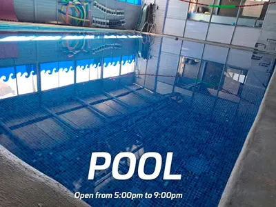 a swimming pool with a net in front of a building at Airport Nest Costa Rica Hotel in Alajuela City