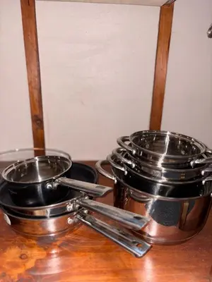 two pans and tongs sitting on a wooden table at Dreams of Golden Wings in Monteverde Costa Rica