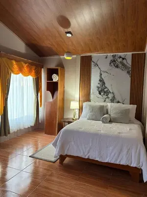 a bedroom with a large bed with a wall at Dreams of Golden Wings in Monteverde Costa Rica