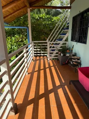 a porch with a wooden fence and stairs at Coco Loco Azul Boutique Apartments by Lucky Vacation Homes in Playa Junquillal