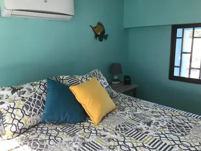 a bedroom with a bed with pillows on it at Coco Loco Azul Boutique Apartments by Lucky Vacation Homes in Playa Junquillal