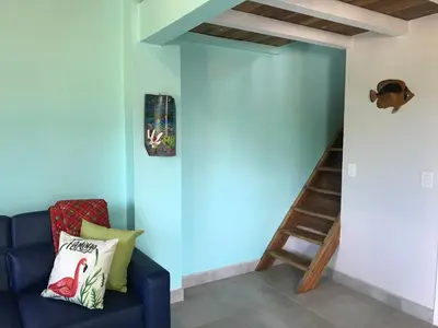 a room with a blue wall with a blue couch and a staircase at Coco Loco Azul Boutique Apartments by Lucky Vacation Homes in Playa Junquillal