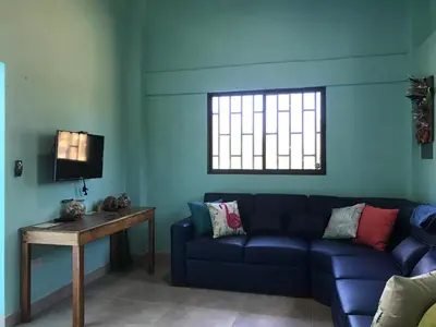 a living room with a blue couch and a table at Coco Loco Azul Boutique Apartments by Lucky Vacation Homes in Playa Junquillal