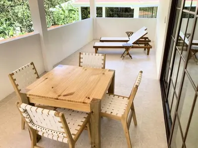 a wooden table and chairs on a patio at New house in Playa Hermosa in Playa Hermosa