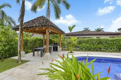 a patio with a gazebo next to a swimming pool at Casa Brisa y Mar - Poolside Bliss, Walk to Beach in Bejuco