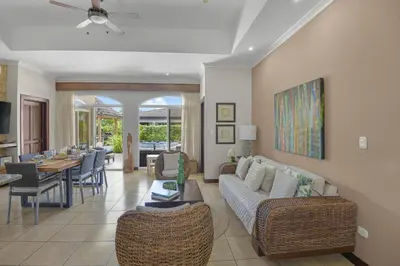 a living room with a couch and a dining room at Casa Brisa y Mar - Poolside Bliss, Walk to Beach in Bejuco