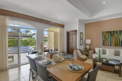 a dining room and living room with a table and chairs at Casa Brisa y Mar - Poolside Bliss, Walk to Beach in Bejuco