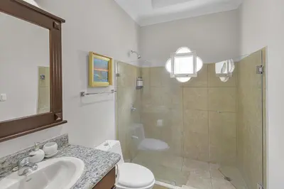 a bathroom with a shower and a toilet and a sink at Casa Brisa y Mar - Poolside Bliss, Walk to Beach in Bejuco