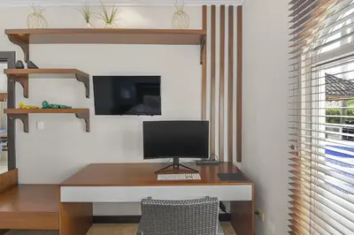 a desk with a computer on it in a room at Casa Brisa y Mar - Poolside Bliss, Walk to Beach in Bejuco