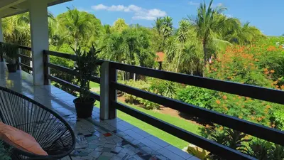 a balcony with a view of a garden at Villa Del Sol Boutique Hotel in Coco
