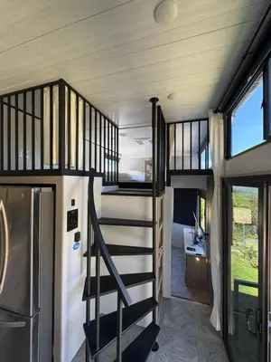a staircase in a tiny house with a bedroom at Villa Sura in Colón
