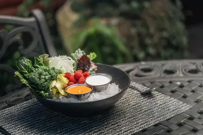 a bowl of fruit and vegetables on a table at Cedrela Eco-Lodge & Restaurante in El Copey