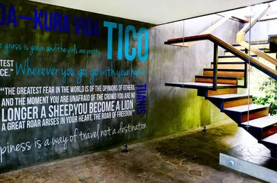 a mural on the wall of a building with a staircase at Kura Boutique Hotel Member of the Cayuga Collection in Uvita