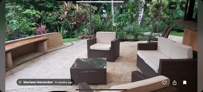 a patio with two white chairs and a table at LaCusuca in Guadalajara