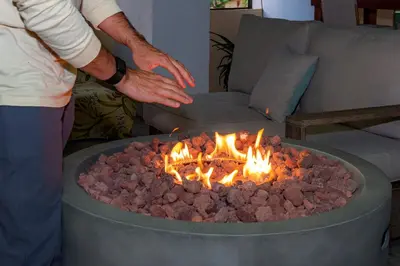 a man standing in front of a fire pit at Bhoga Forest
