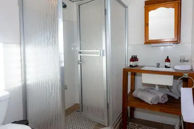 a bathroom with a shower and a sink at Bhoga Forest