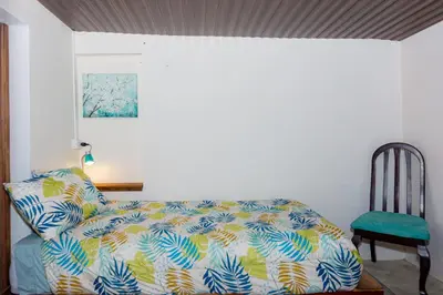 a bedroom with a bed and a chair at Bhoga Forest
