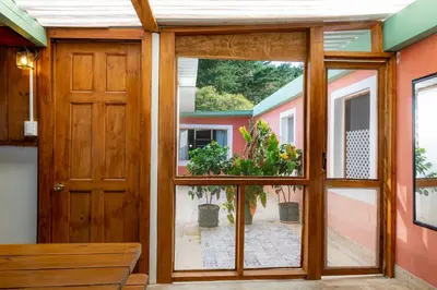 a room with a door and a window with plants at Bhoga Forest