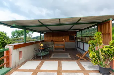 a deck of a house with a pergola at Bhoga Forest