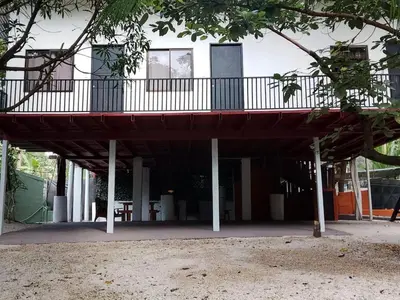 a building with a balcony on top of it at El Bosque Apartments in Sámara