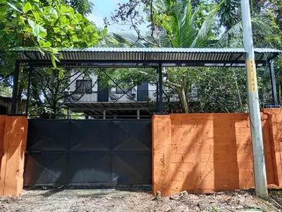 a black fence with a building in the background at El Bosque Apartments in Sámara
