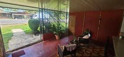 a screened in porch with a view of a yard at Anita's Apartment in Upala