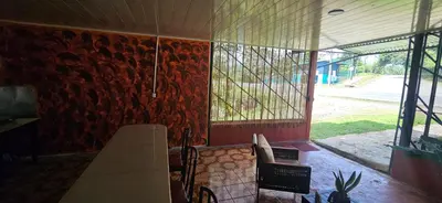 a room with a stone wall with a window at Anita's Apartment in Upala