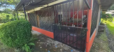 a building with a gate in front of it at Anita's Apartment in Upala
