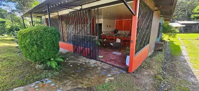 a house with an open door with a patio at Anita's Apartment in Upala