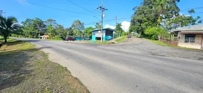 an empty road in a village with a house at Anita's Apartment in Upala