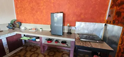 a kitchen with a counter and a refrigerator in it at Anita's Apartment in Upala