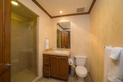 a bathroom with a sink and a toilet and a shower at Veranda 1B - 3 bdr 3 bath in La Mona