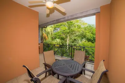 a dining room with a table and chairs on a balcony at Veranda 1B - 3 bdr 3 bath in La Mona