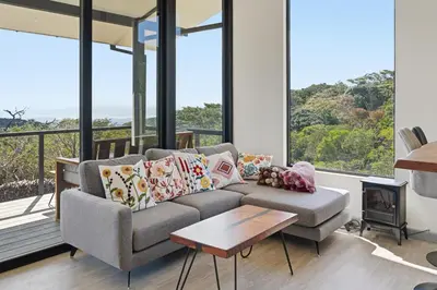 a living room with a couch and a fireplace at Casas Oria Monteverde in Monteverde Costa Rica