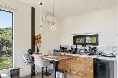 a kitchen with a wooden table and chairs at Casas Oria Monteverde in Monteverde Costa Rica