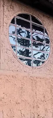 a window on the side of a building at Infinite Stillness Farm in Buenos Aires