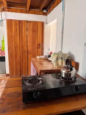 a kitchen with a stove with a tea kettle on it at Casa Almendros in Cabuya