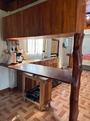 a kitchen with a large wooden table in a kitchen at Casa Almendros in Cabuya