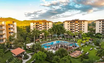 an aerial view of a resort with a pool and palm trees at COSTA LINDA Charming 1-03 in Jacó