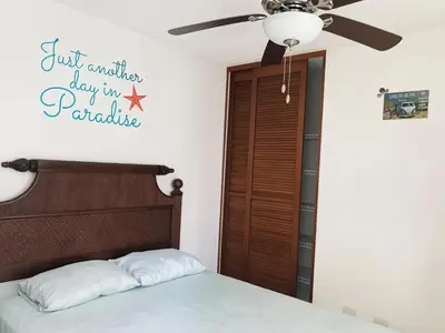 a bedroom with a bed and a ceiling fan at COSTA LINDA Charming 1-03 in Jacó