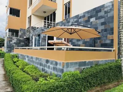 a patio with an umbrella next to a building at COSTA LINDA Charming 1-03 in Jacó