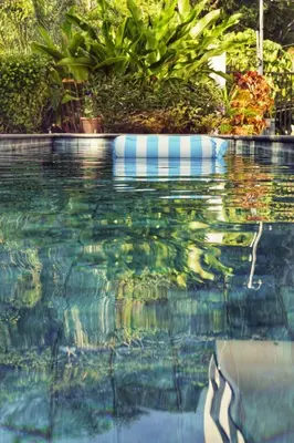 a swimming pool with a reflection in the water at Casa Kimara in Uvita